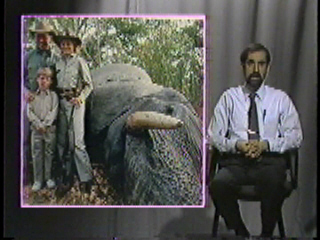 A family of hunters posing by an elephant they killed