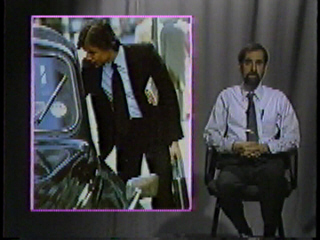 A business man reaching into a car