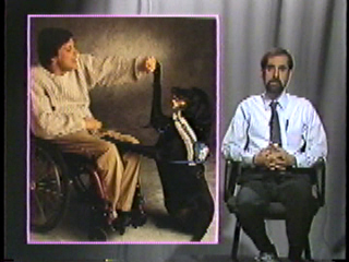 A man in a wheelchair with his dog next to him