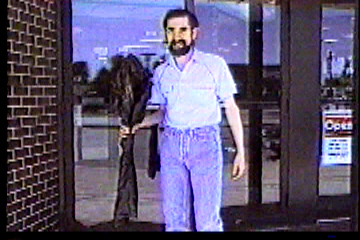 Outside sporting goods store with newly purchased rifle