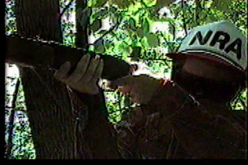 Close-up of hunter pulling trigger on rifle