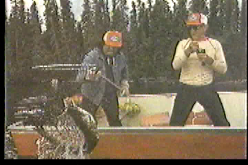 Fishermen hauling a fish into their boat