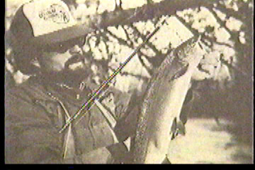 Fisherman with a hooked fish