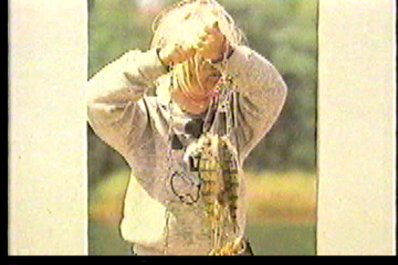 Young girl holding up fish she has killed
