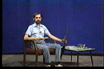 Steve in studio reaching for gun.