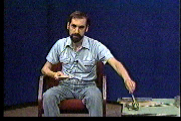 Steve in studio, springing the leg-hold trap with a pen