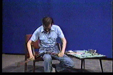 Steve in studio breaking gun over his knee