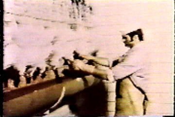 A butcher cuts the throats of the chickens that were missed by the machine.